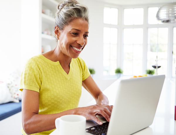Mature woman smiling at her computer